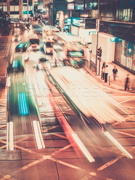 Fast moving cars at night in modern city Stock photo © Nejron