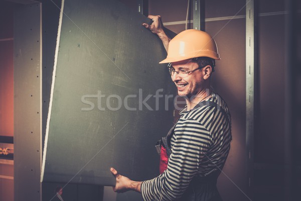 Builder with plasterboard in new building interior  Stock photo © Nejron