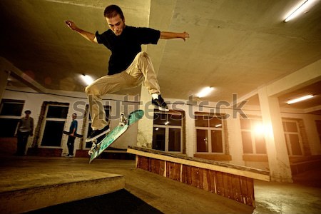 Young man performing a stunt in a skatepark Stock photo © Nejron