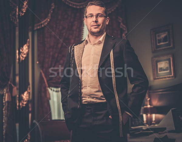 Middle-aged man trying on custom made suit in luxury vintage interior  Stock photo © Nejron