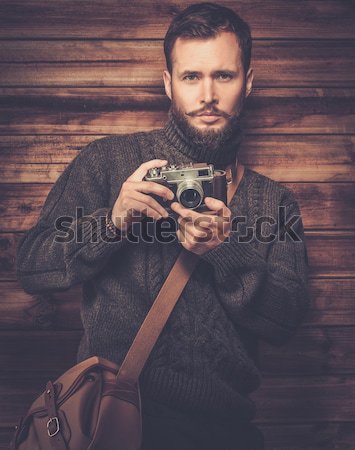 Man with beard in checkered shirt holding camera  Stock photo © Nejron