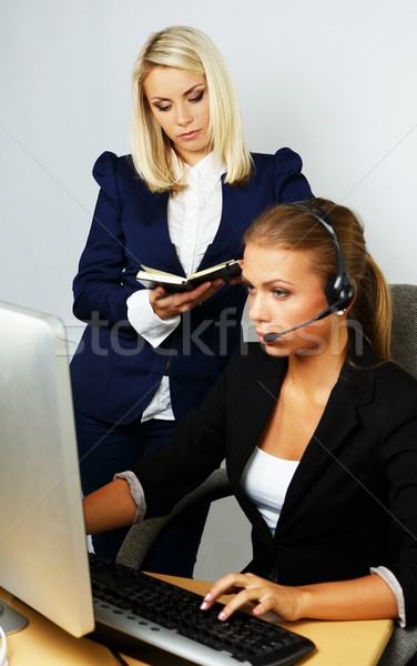 Beautiful help desk office support woman with female boss behind her Stock photo © Nejron