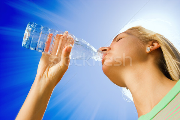 Beautiful blond girl drinking water Stock photo © Nejron