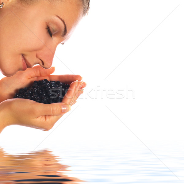 Beautiful girl with a handful of blueberries in rendered water Stock photo © Nejron