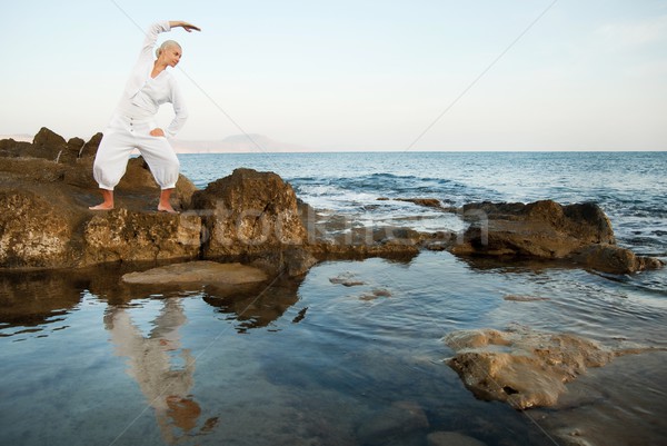 Young woman doing yoga exercise outdoors Stock photo © Nejron
