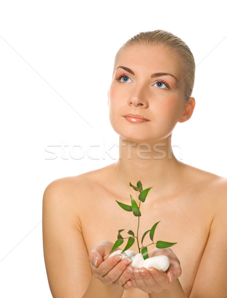 Stock photo: Beautiful blond girl holding young plant growing up through ston