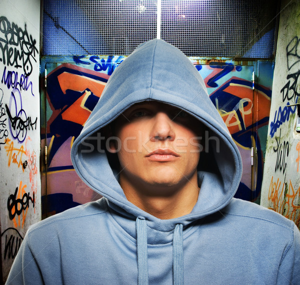 Cool looking hooligan in a graffiti painted gateway Stock photo © Nejron