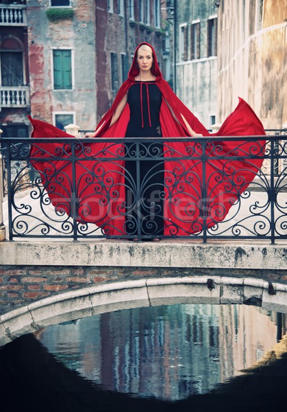 Beautifiul woman in red cloak on a bridge. Stock photo © Nejron