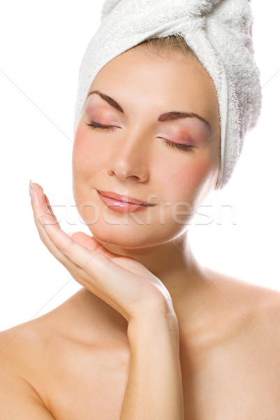 Young lovely lady applying moisturizer to her face after shower Stock photo © Nejron