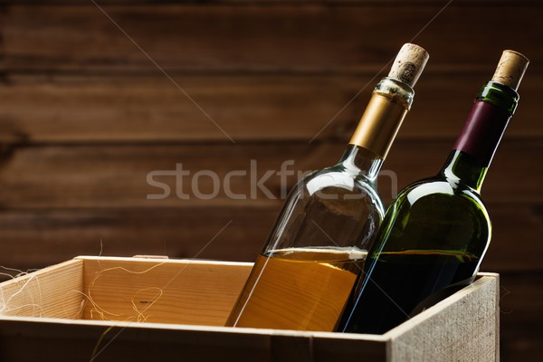 Bottle of red and white wine in wooden box Stock photo © Nejron