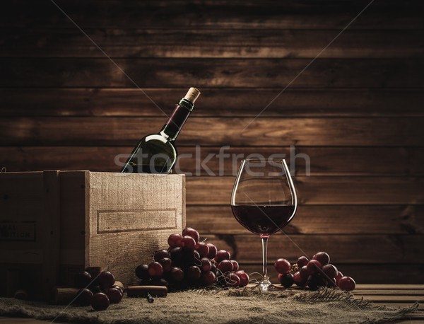 Bottle, glass and red grape on a wooden table  Stock photo © Nejron