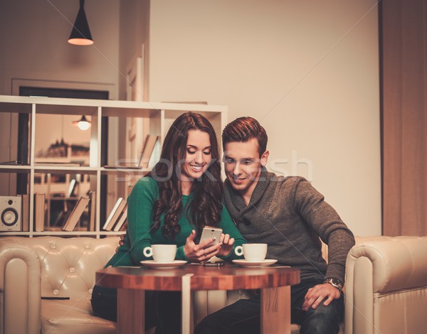 Young couple looking something in mobile phone  Stock photo © Nejron