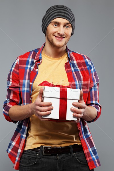 Stylish young man in shirt and beanie hat with gift box Stock photo © Nejron