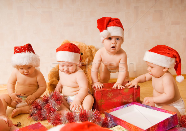 Group of adorable toddlers in Christmas hats packing presents Stock photo © Nejron