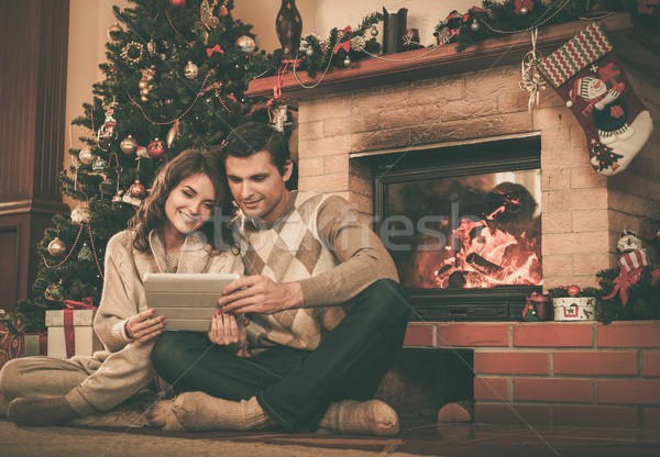 Couple near fireplace in Christmas decorated house interior  Stock photo © Nejron