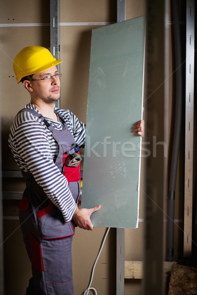 Builder with plasterboard in new building interior  Stock photo © Nejron