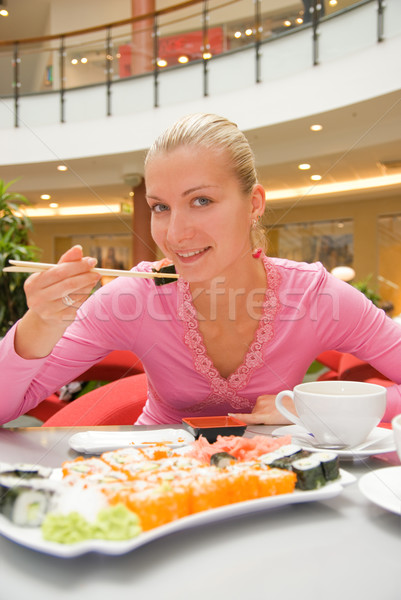 Girl eating sushin in a restaurant Stock photo © Nejron