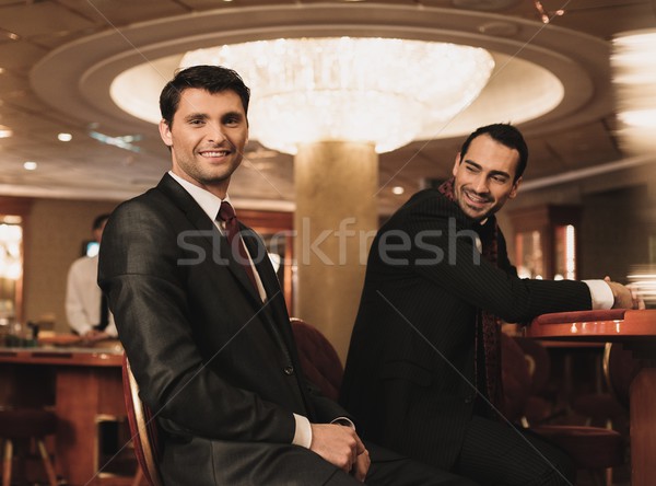 Two young men in suits behind table in a casino Stock photo © Nejron