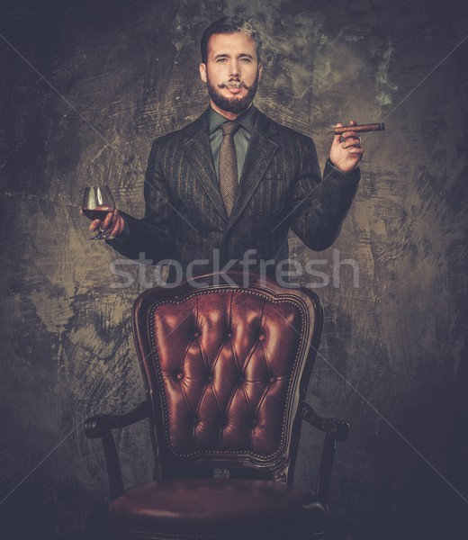Stock photo: Handsome well-dressed with glass of beverage and cigar