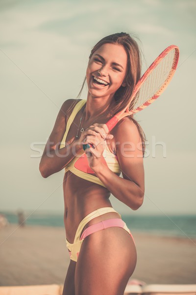 Young girl in swimming suit on a beach with racquet  Stock photo © Nejron