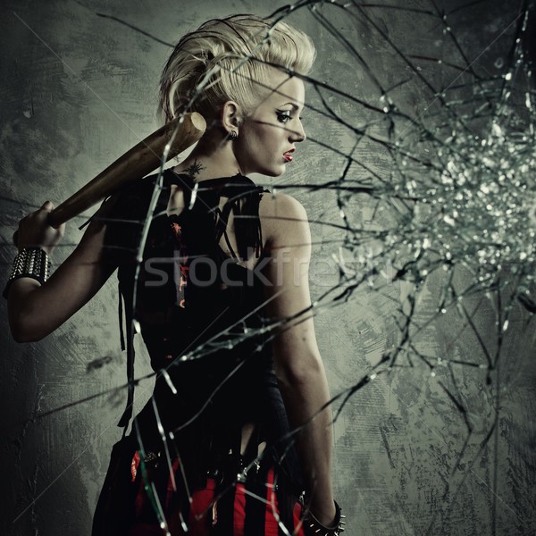 Punk girl with a bat behind broken glass Stock photo © Nejron