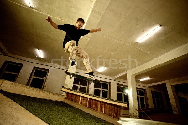 Young man performing a stunt in a skatepark Stock photo © Nejron