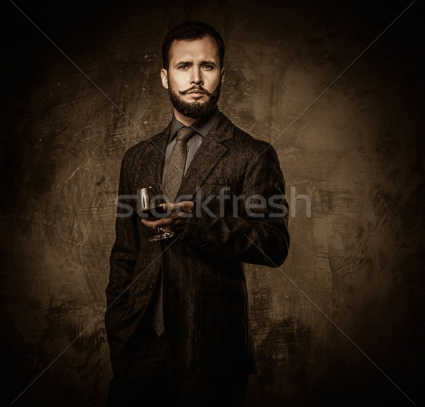Handsome well-dressed with glass of beverage  Stock photo © Nejron
