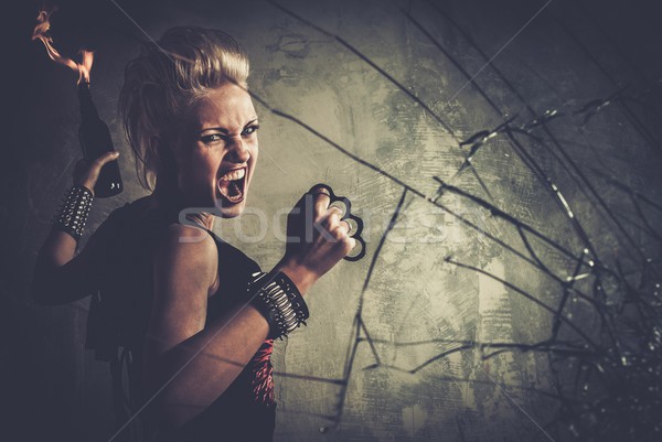 Punk girl with brass knuckles and Molotov cocktail  Stock photo © Nejron