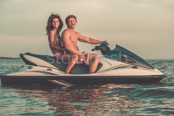 Multi ethnic couple sitting on a jet ski Stock photo © Nejron