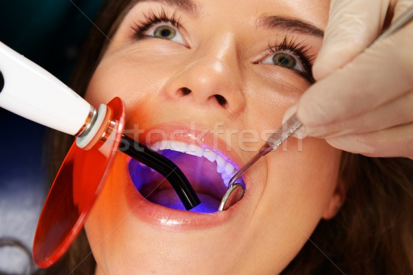 Young woman patient stopping treatment with dental UV light equipment Stock photo © Nejron