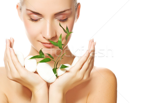 Beautiful young woman holding plant growing up through stones
 Stock photo © Nejron