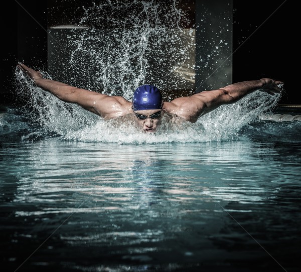 Young man in swimming cap and goggles swim using breaststroke technique  Stock photo © Nejron