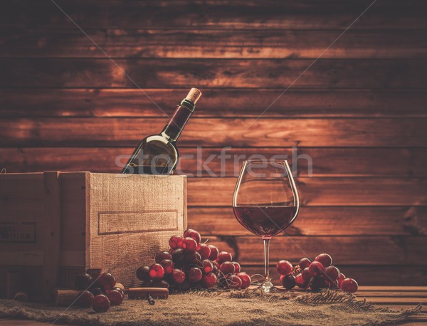 Bottle, glass and red grape on a wooden table  Stock photo © Nejron