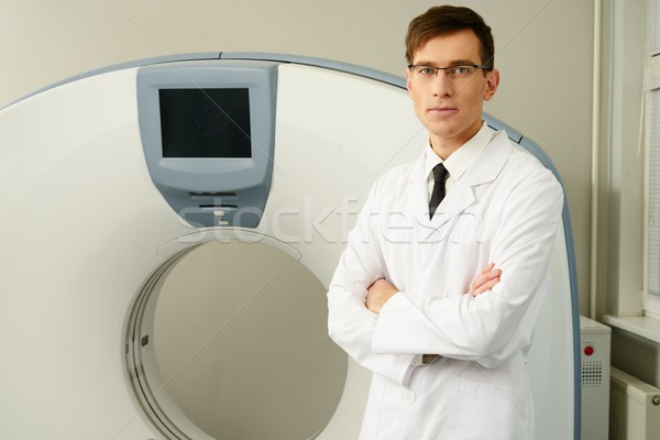 Young doctor standing near computed tomography scanner in a hospital Stock photo © Nejron