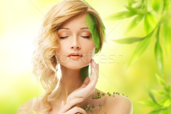 Beautiful young dreaming woman in conceptual spring costume touching her face Stock photo © Nejron