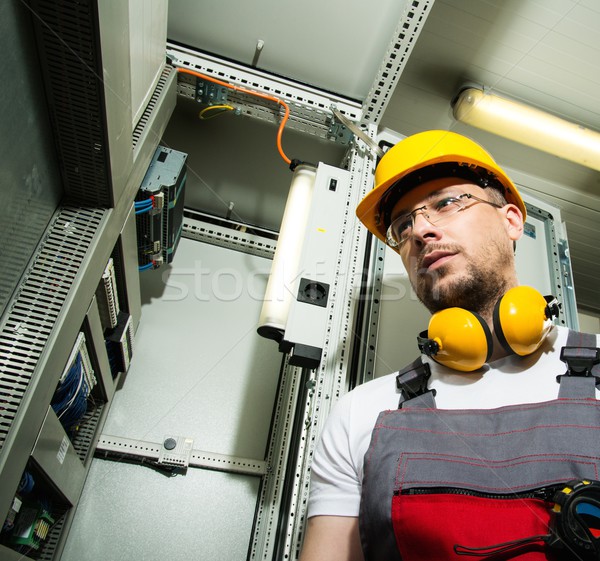 Electrician in a safety hat and headphones on a factory Stock photo © Nejron