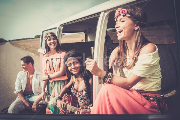Multi-ethnic hippie friends with guitar on a road trip Stock photo © Nejron