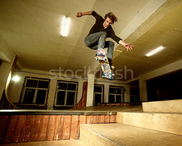 Young man performing a stunt in a skatepark Stock photo © Nejron