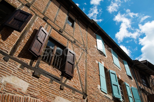 Red brick building facade with wooden shutters  Stock photo © Nejron