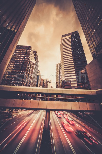 Fast moving cars at night in modern city Stock photo © Nejron