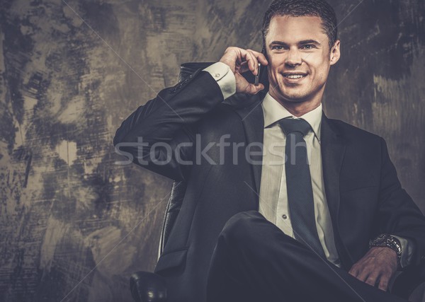 Well-dressed man in black suit with mobile phone Stock photo © Nejron