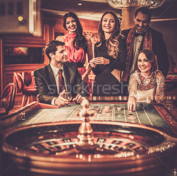 Group of stylish people playing in a casino Stock photo © Nejron