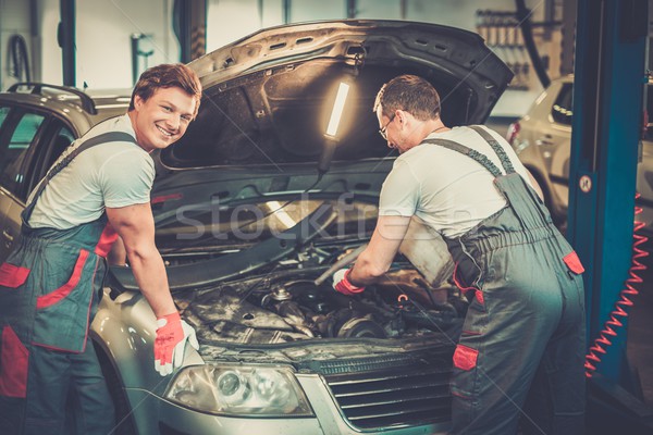 Two mechanics fixing car in a workshop Stock photo © Nejron