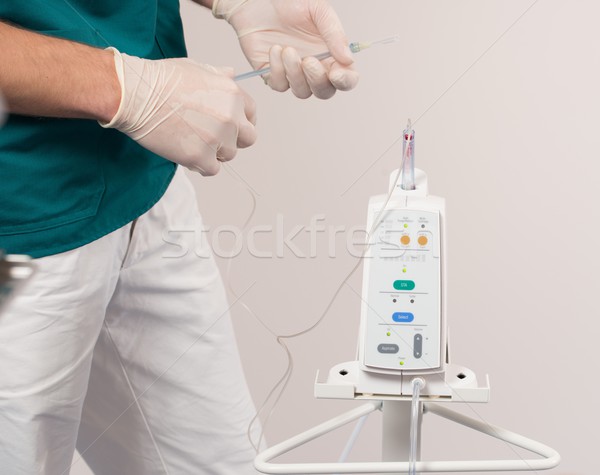 Doctor with intravenous pump machine in dental surgery Stock photo © Nejron