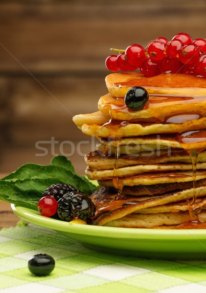 Tasty pancakes with maple syrup and fresh berries on a plate  Stock photo © Nejron