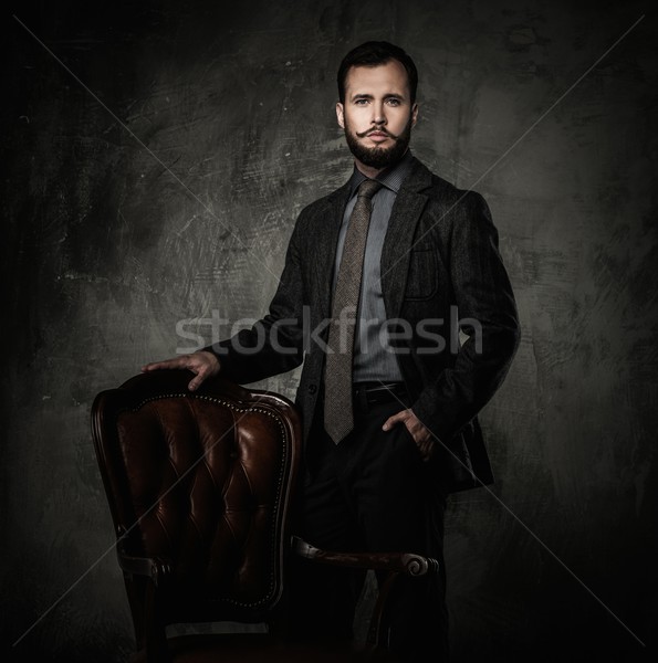Handsome well-dressed  standing leather chair  Stock photo © Nejron