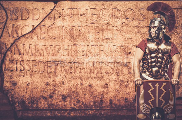 Roman legionary soldier in front of  wall with ancient writing  Stock photo © Nejron