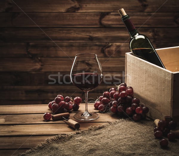 Bottle, glass and red grape on a wooden table  Stock photo © Nejron