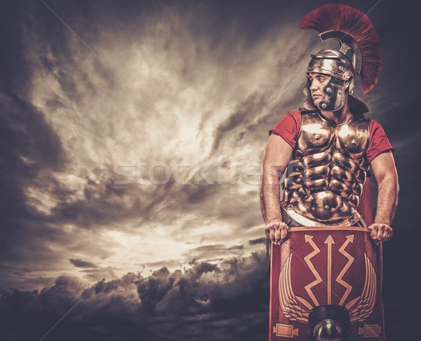 Stock photo: Legionary soldier against stormy sky
