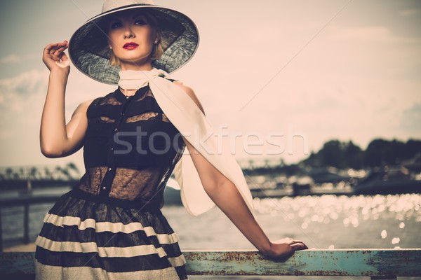Woman in white hat and scarf standing near old pier rails  Stock photo © Nejron